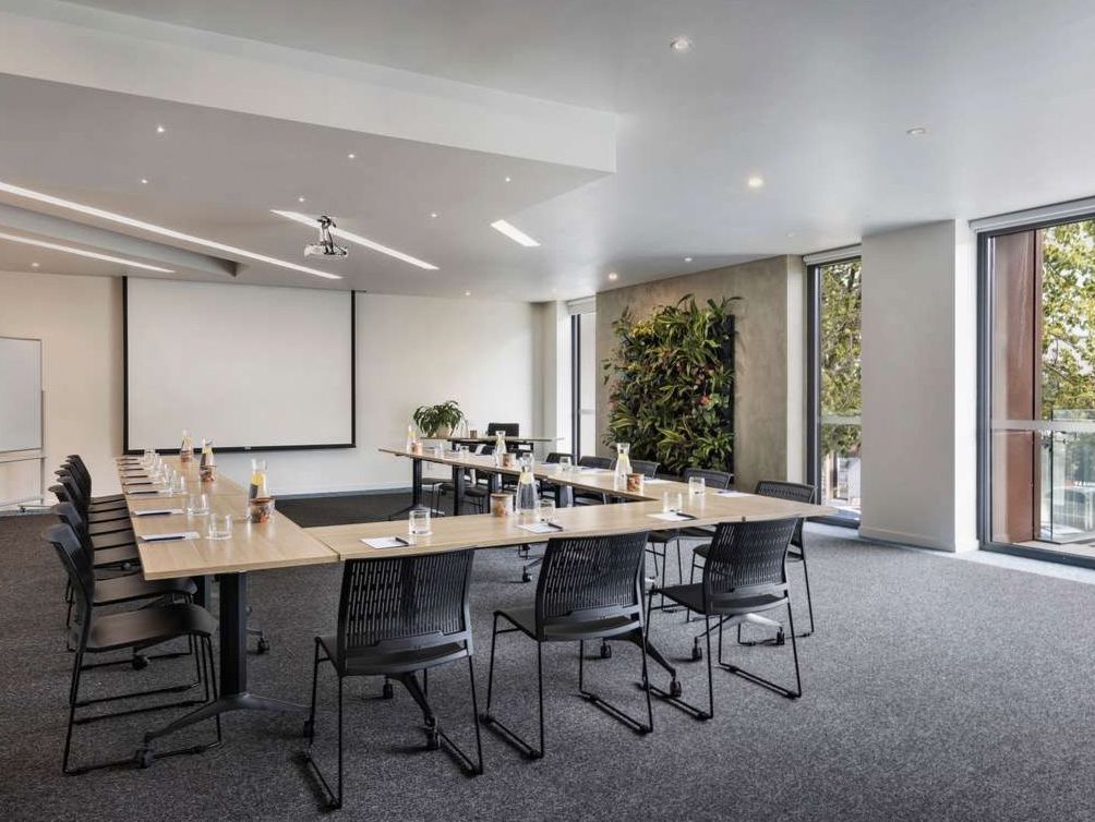 Conference room with boardroom table and natural light at Happymotion